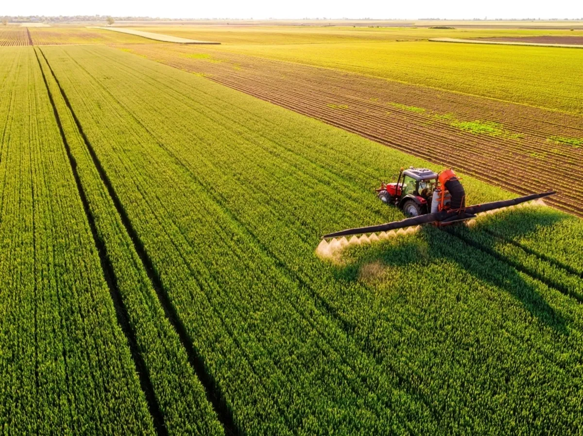 A drone photo of a field with a tractor | Skylum Blog