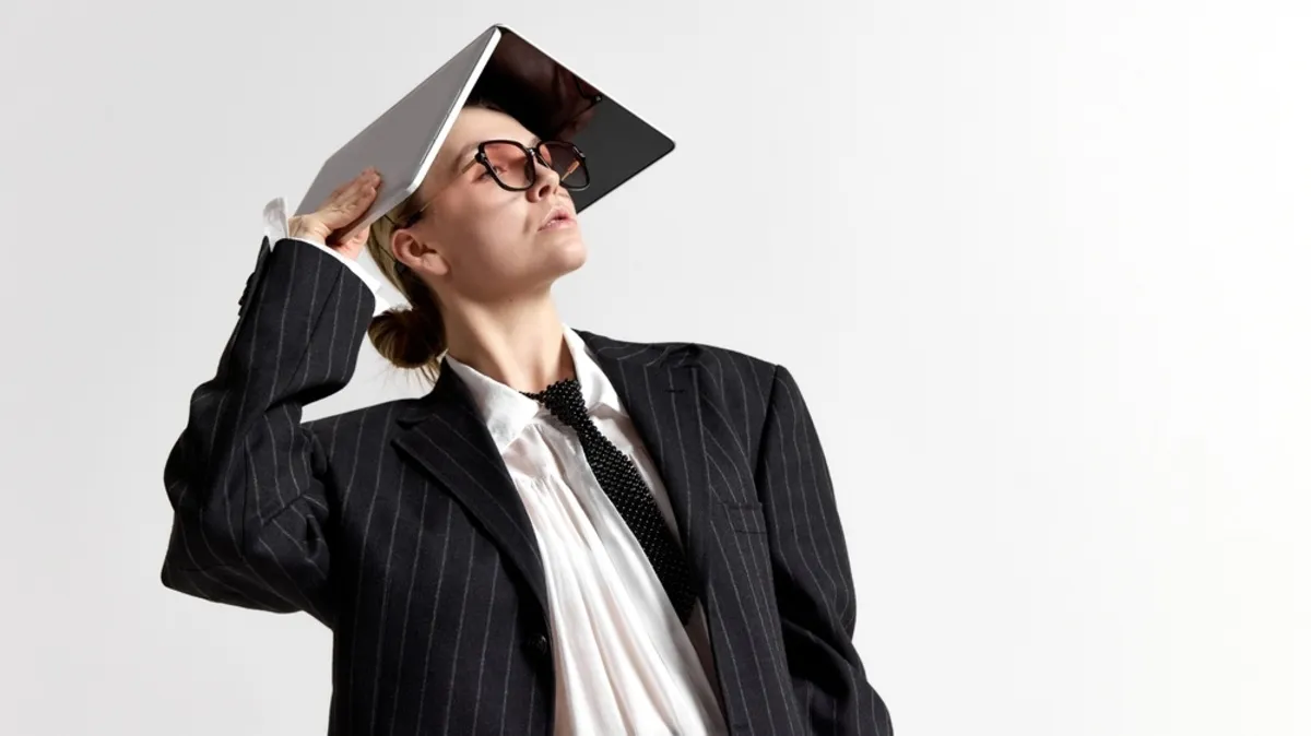 A girl in glasses with a laptop on her head | Skylum Blog