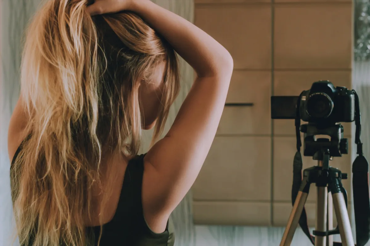 A girl holds her hair in front of the camera | Skylum Blog