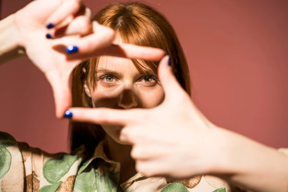 Portrait of a girl with hands in front of her face | Skylum Blog