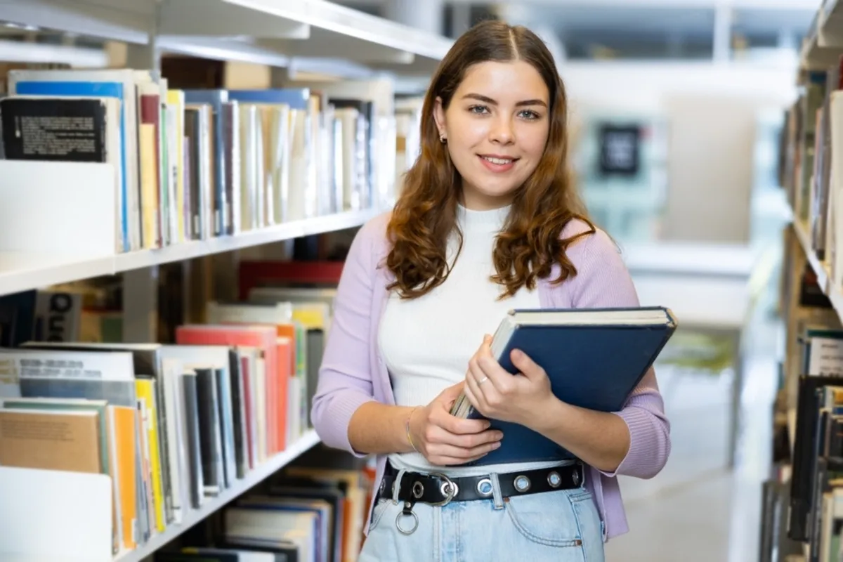 The girl holds a book in her hands | Skylum Blog