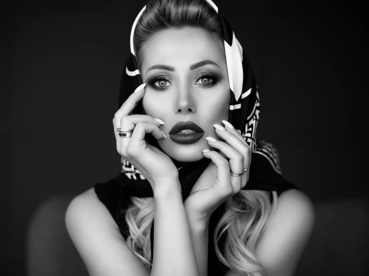 Girl in headscarf holds hands on face | Skylum Blog