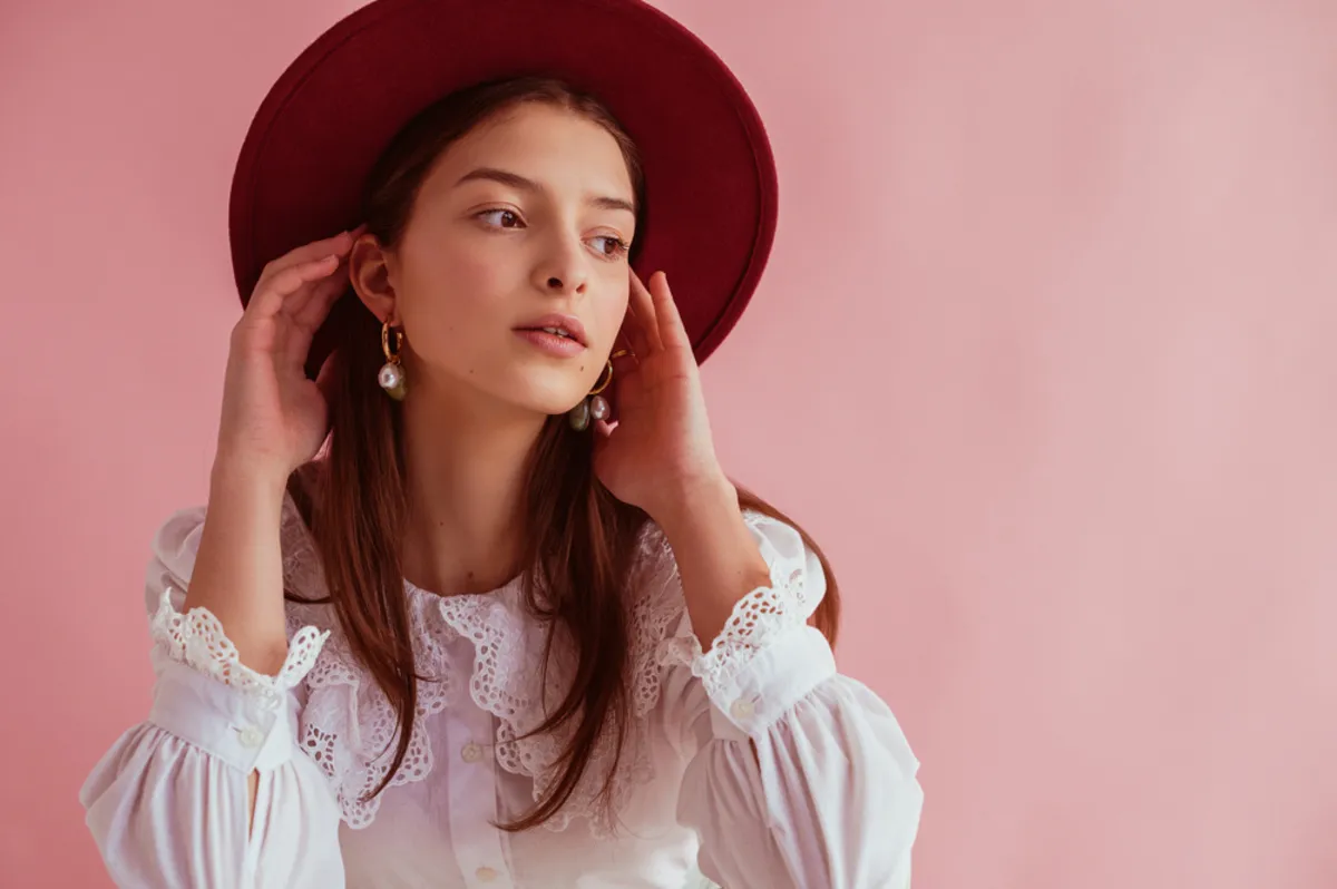 Portrait of a girl with hands near her ears | Skylum Blog