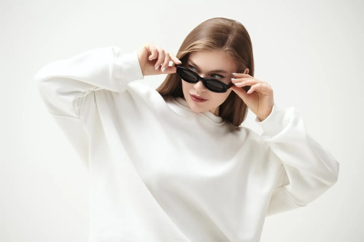 Portrait of a girl with hands on glasses | Skylum Blog