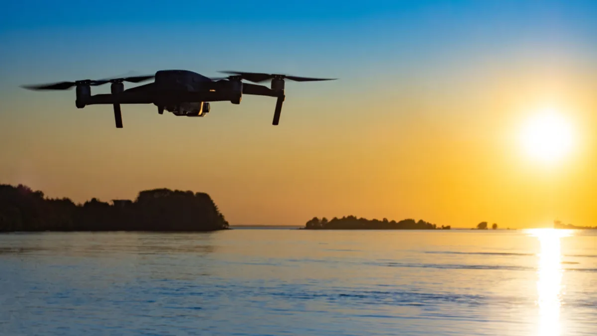 Photo of a drone flying over water | Skylum Blog