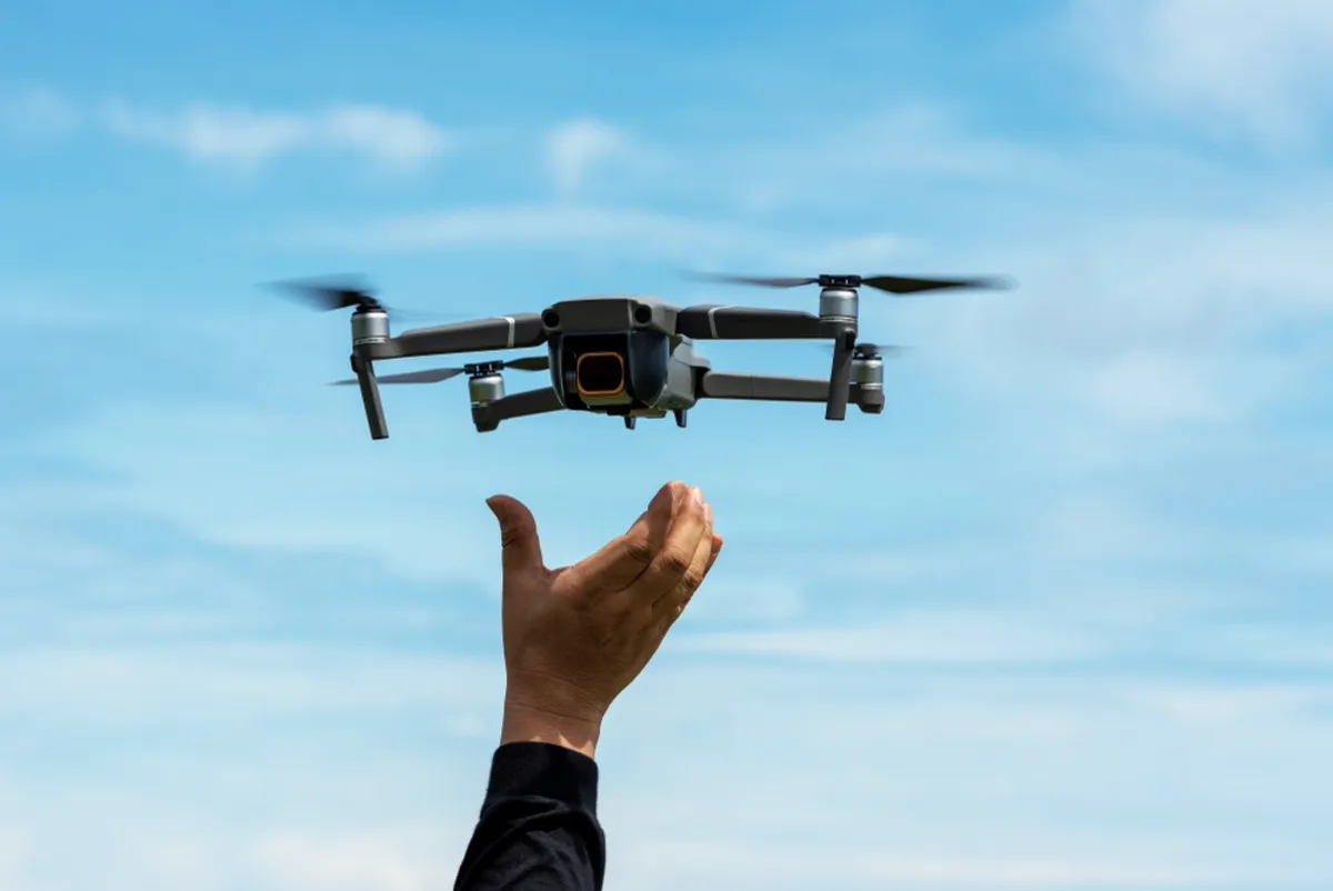 A man's hand and a drone | Skylum Blog
