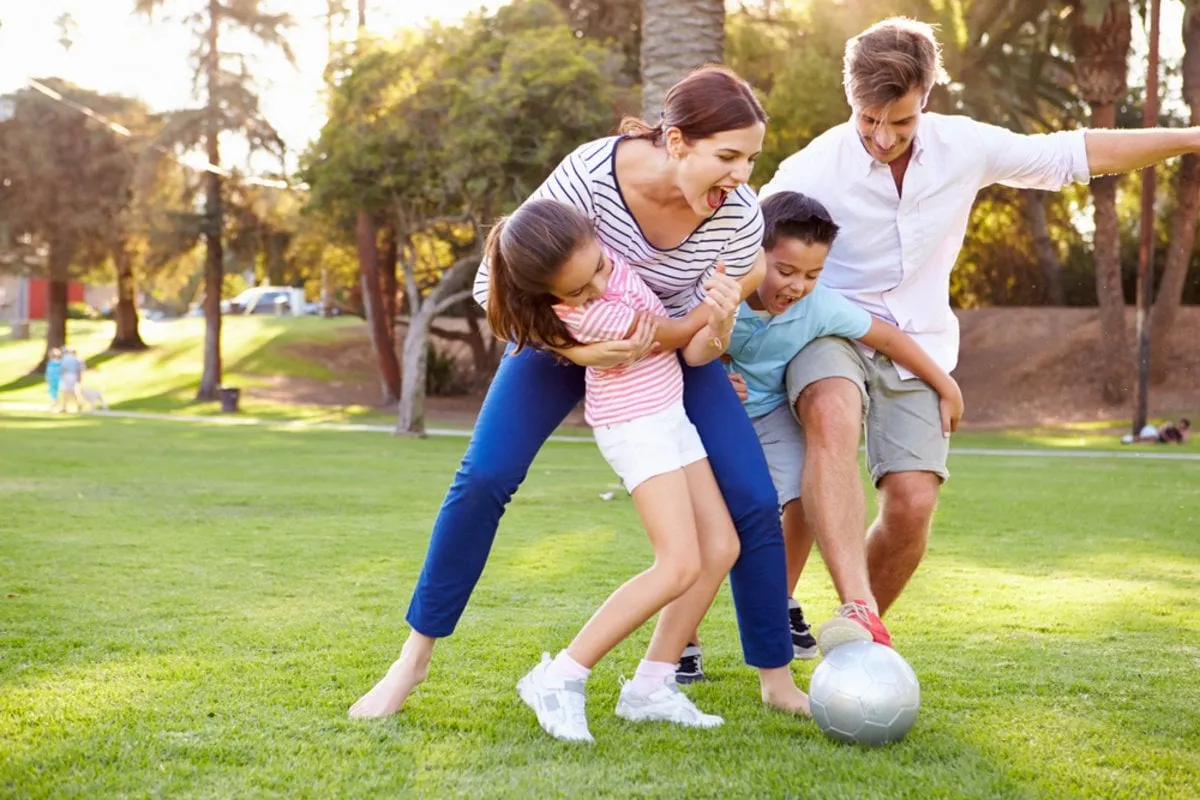 A photo of a family playing football | Skylum Blog
