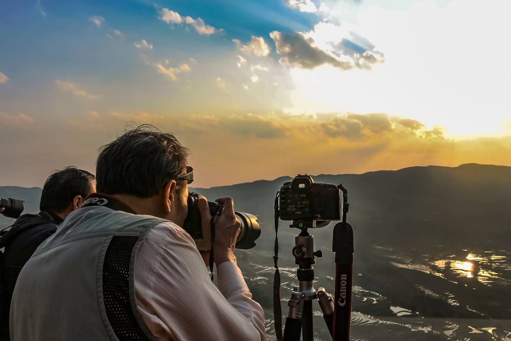 A photographer is photographing the sunset