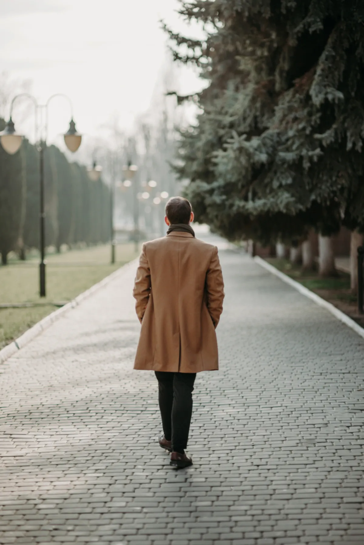 A photo of a man walking on the sidewalk from behind | Skylum Blog