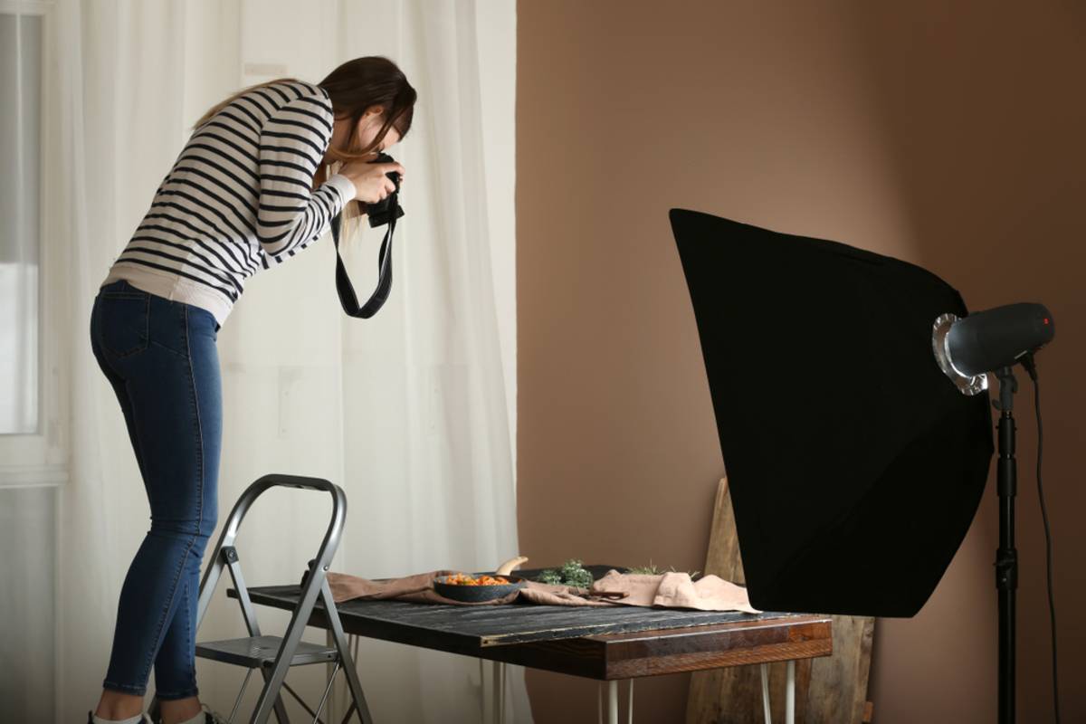 Woman photographing food with artificial light | Skylum Blog

