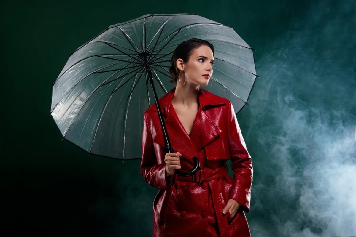 A girl in a red raincoat under an umbrella | Skylum Blog