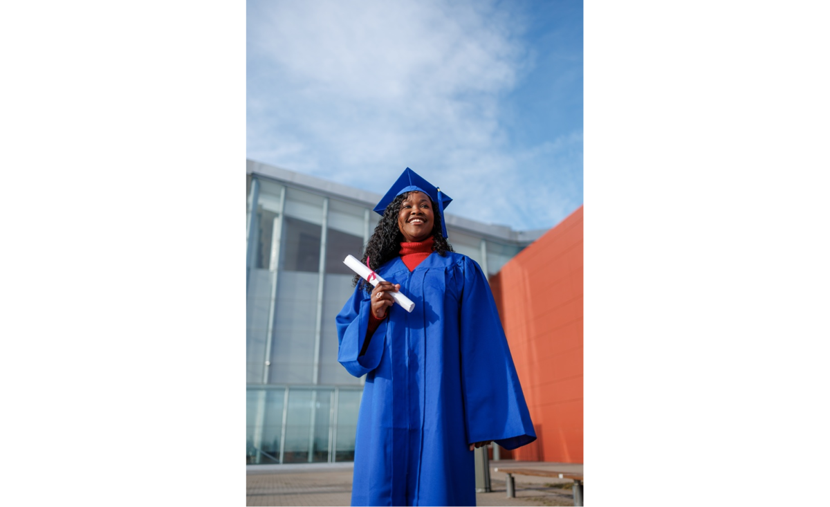 Graduate standing beside a modern building | Skylum Blog

