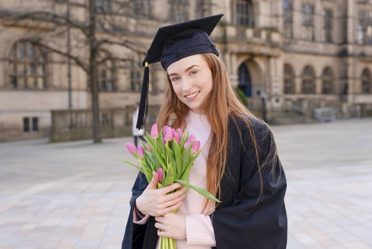 Graduate holding flowers outdoors | Skylum Blog


