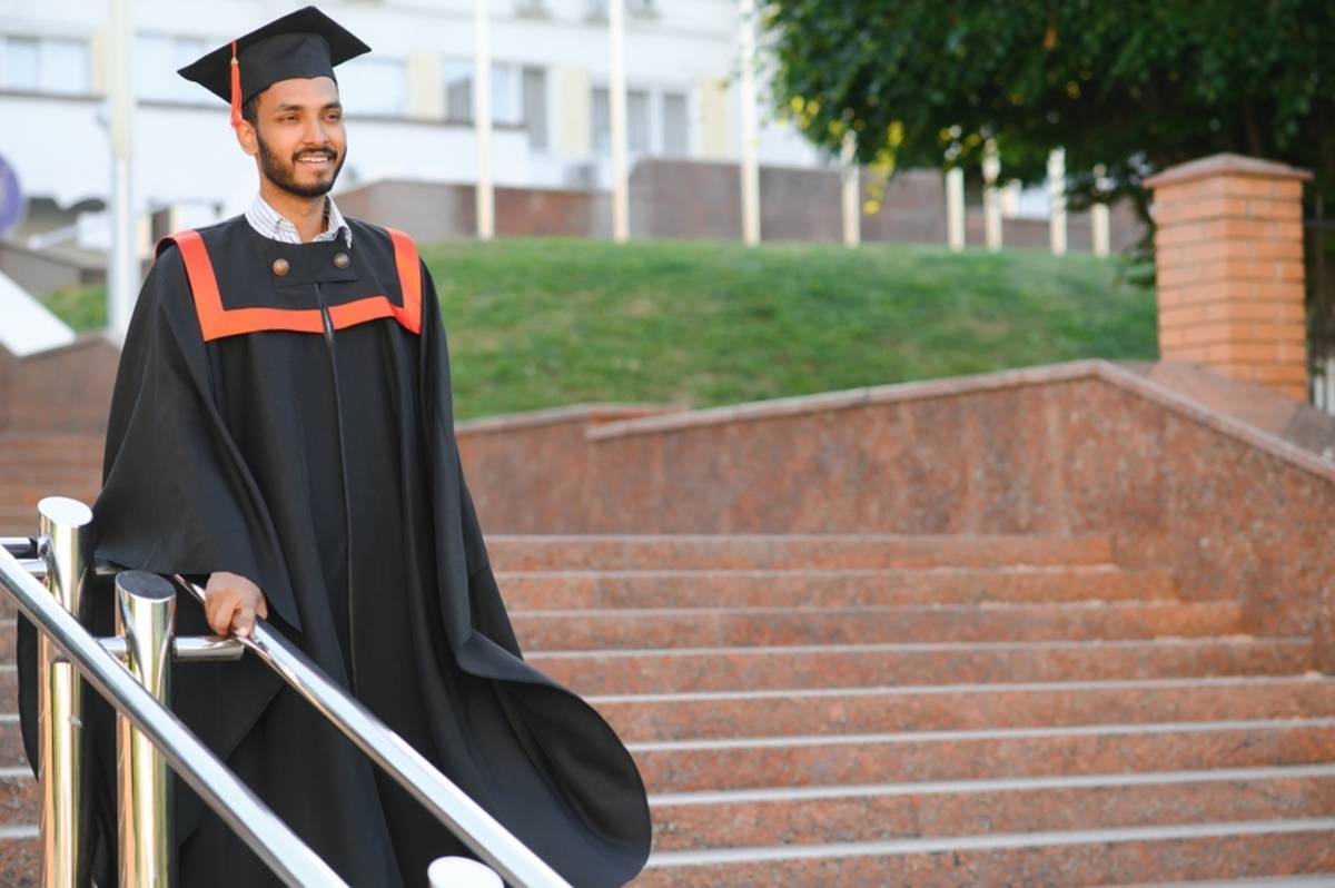 Graduate walking down outdoor steps | Skylum Blog

