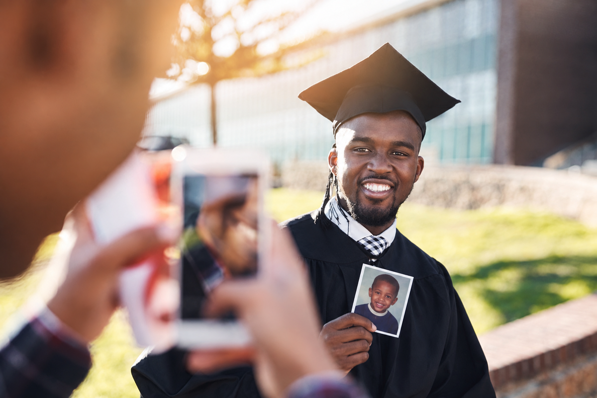 Graduate posing for a photo outdoors | Skylum Blog

