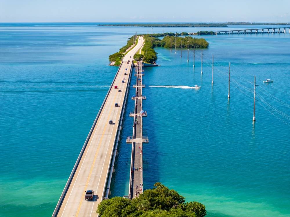 Long bridge over bright blue ocean water | Skylum Blog

