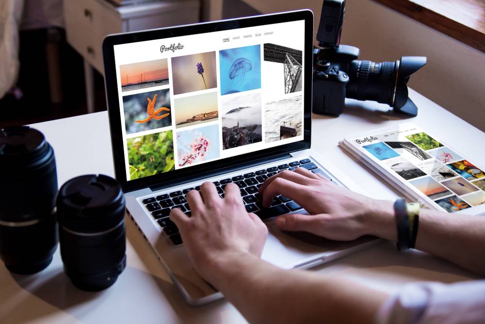 Photographer browsing visual portfolio on a laptop | Skylum Blog