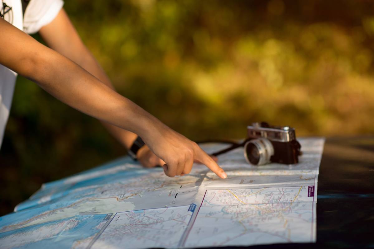 Person pointing at a map outdoors with camera | Skylum Blog

