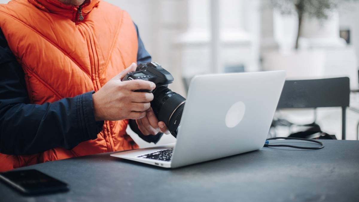 Photographer working on laptop at desk | Skylum Blog


