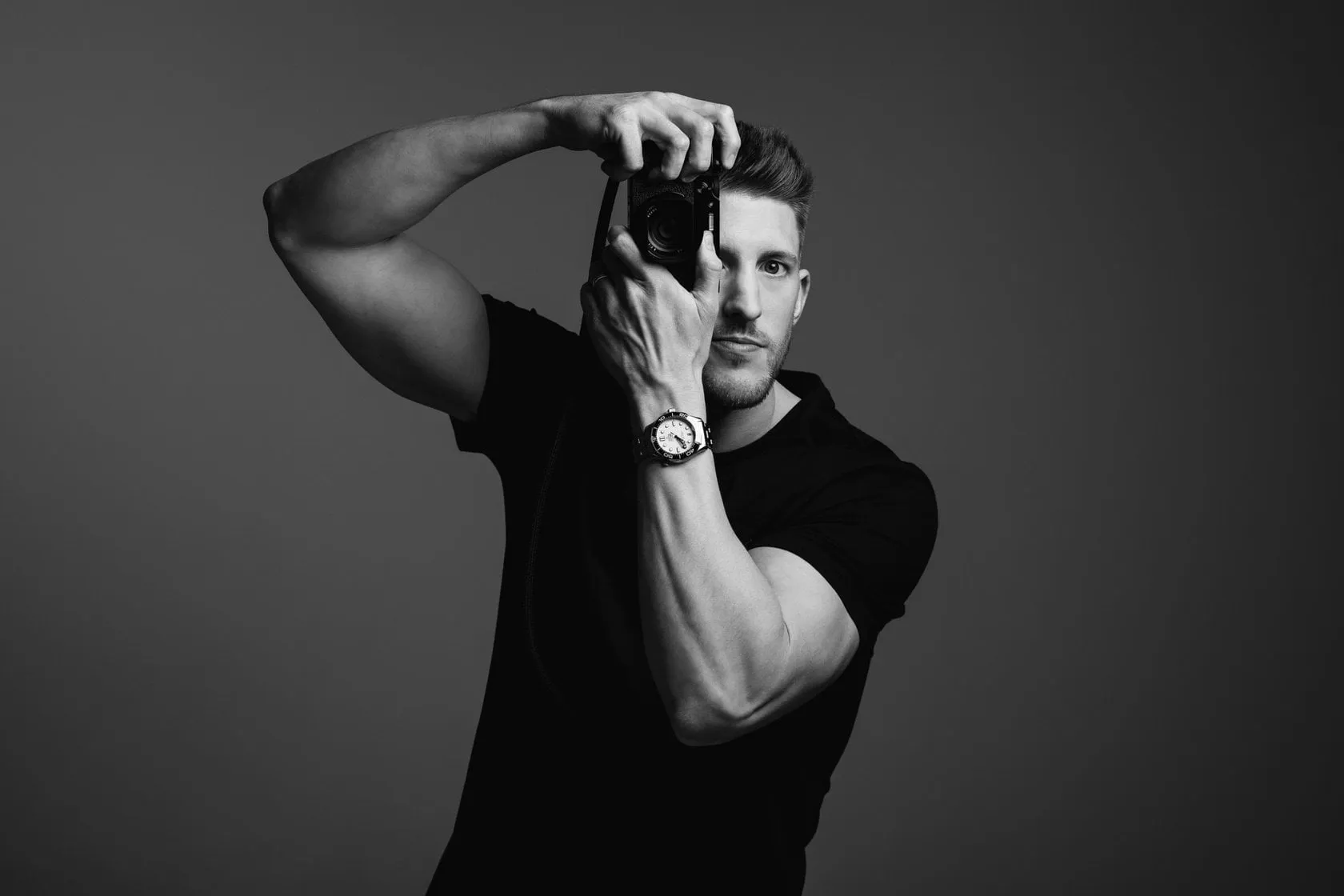 Portrait of a Young Man Holding a Camera | Skylum Blog