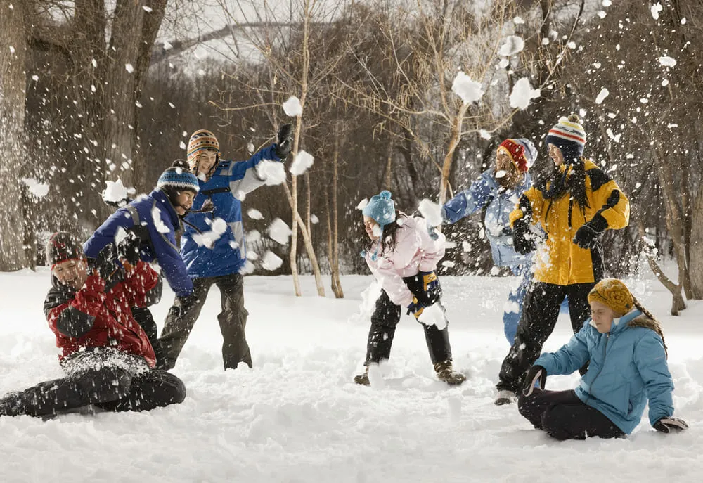 Family Playing Snowballs Outside | Skylum Blog