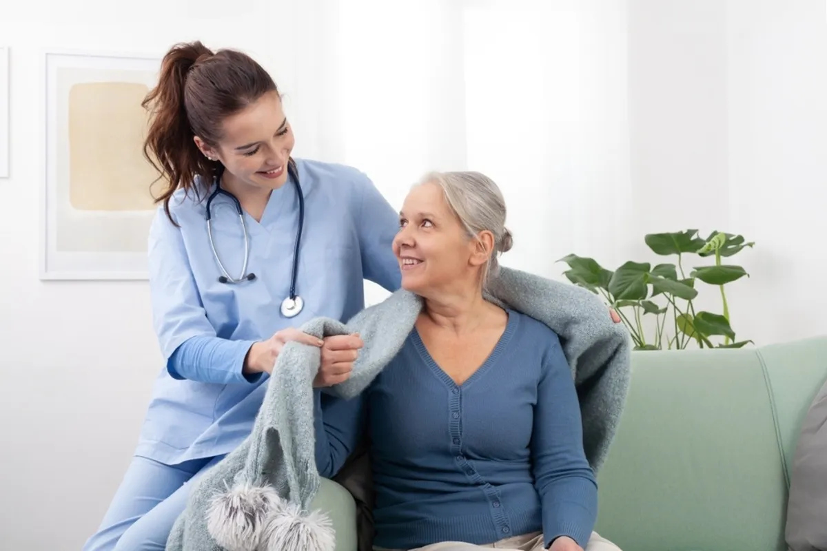 A nurse covers a patient with a blanket | Skylum Blog