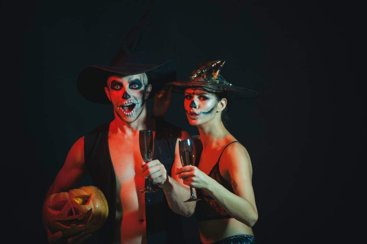 Two people surrounded by colorful Halloween lighting | Skylum Blog

