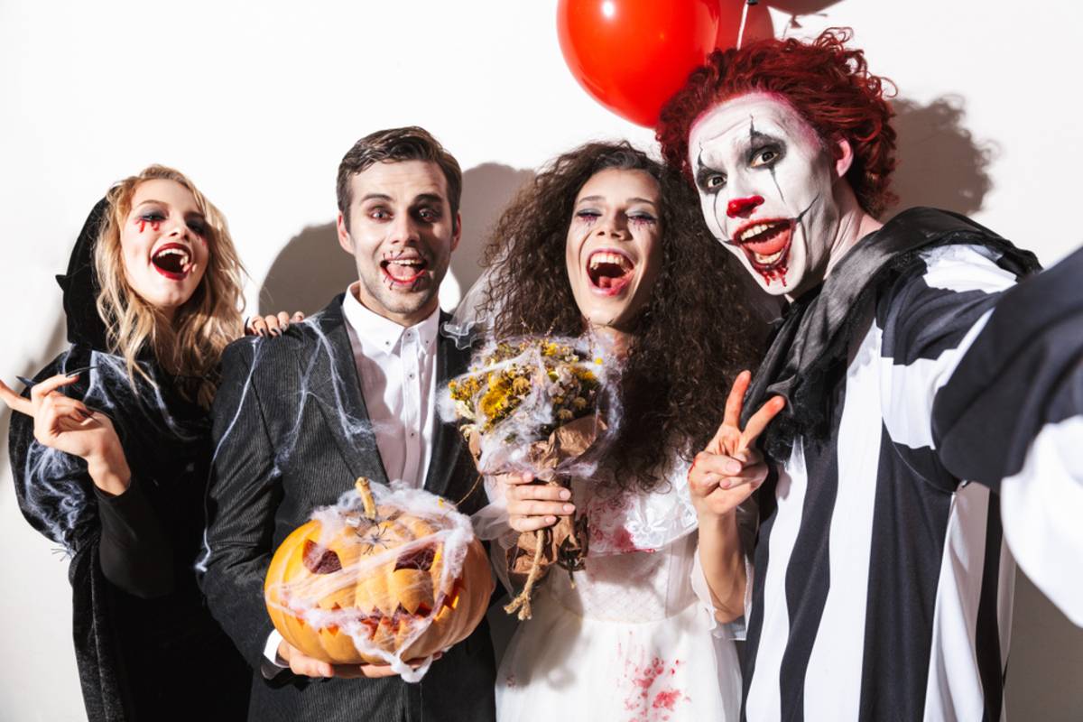 Group of people posing together in Halloween costumes | Skylum Blog

