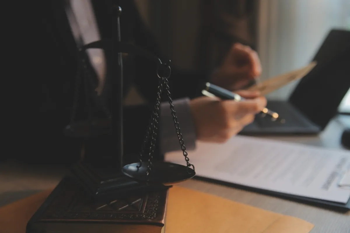 Lawyer with documents at the computer | Skylum Blog