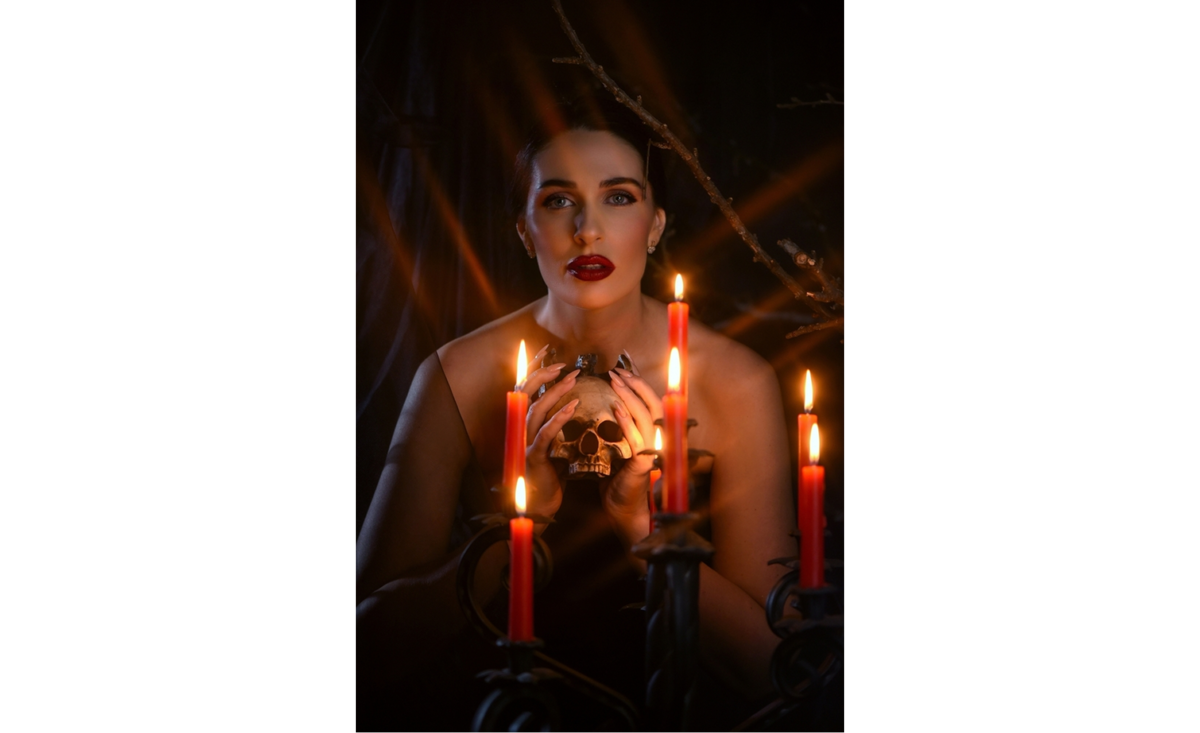 Woman holding candles in a dark room | Skylum Blog

