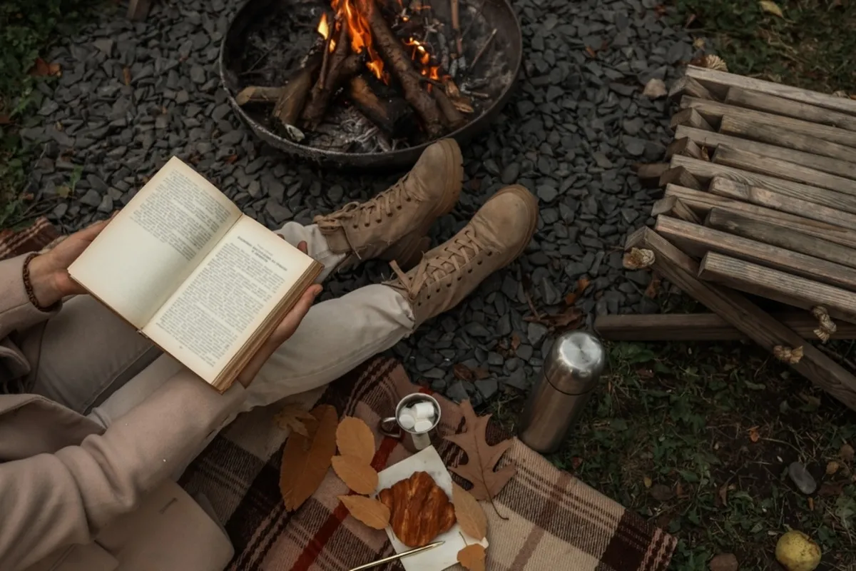An autumn photo with a book by the fire | Skylum Blog