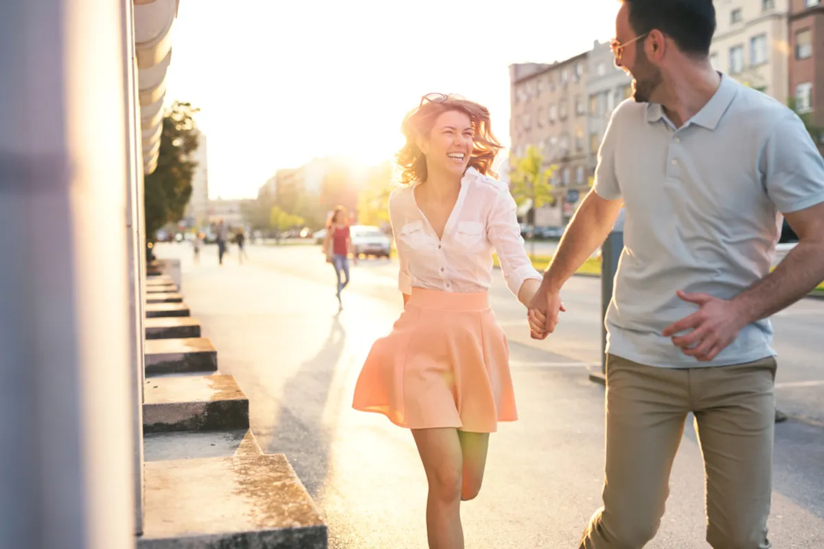 A guy and a girl running around the city | Skylum Blog