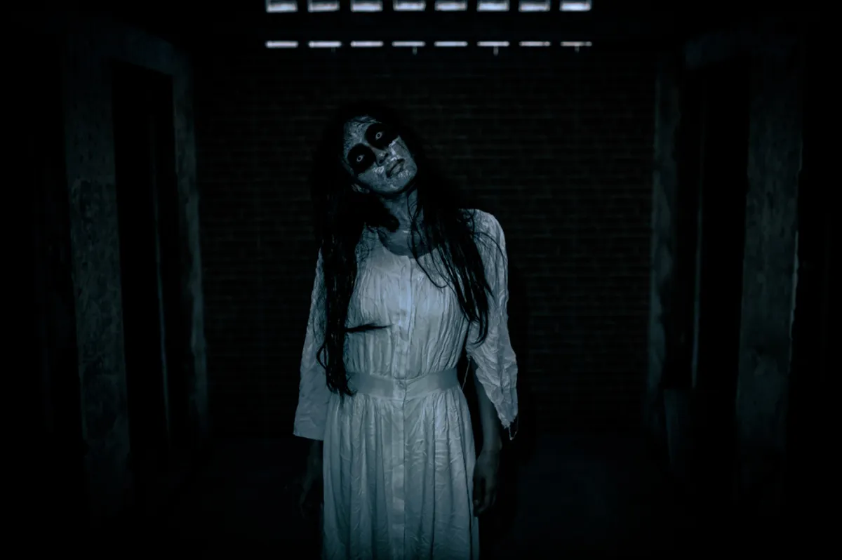 A girl with black hair a white dress black circles under her eyes | Skylum Blog