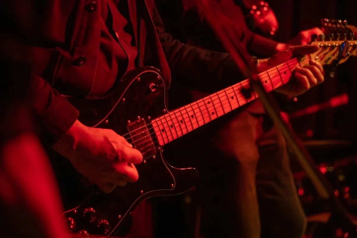 Photo of a guitar at a concert close up | Skylum Blog