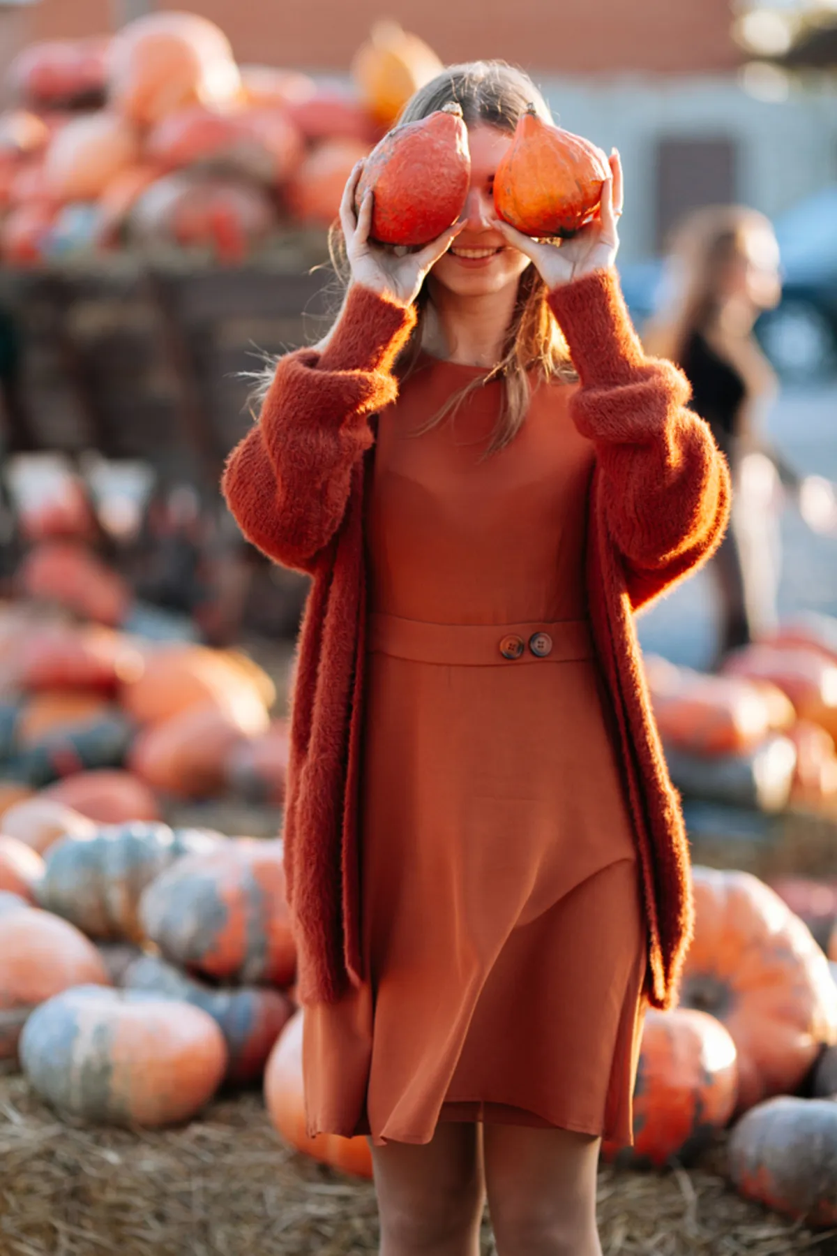 A girl holds pumpkins in her hands | Skylum Blog