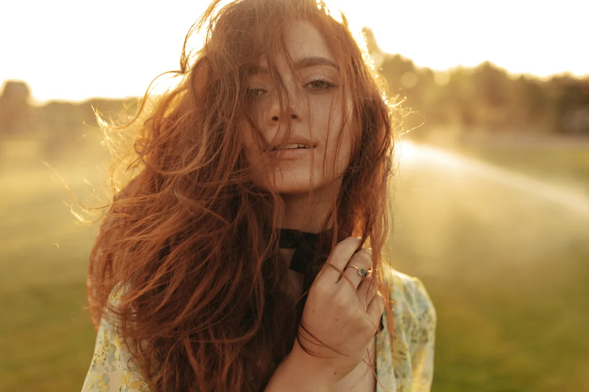 Portrait of a girl at golden hour with the sun behind her | Skylum Blog