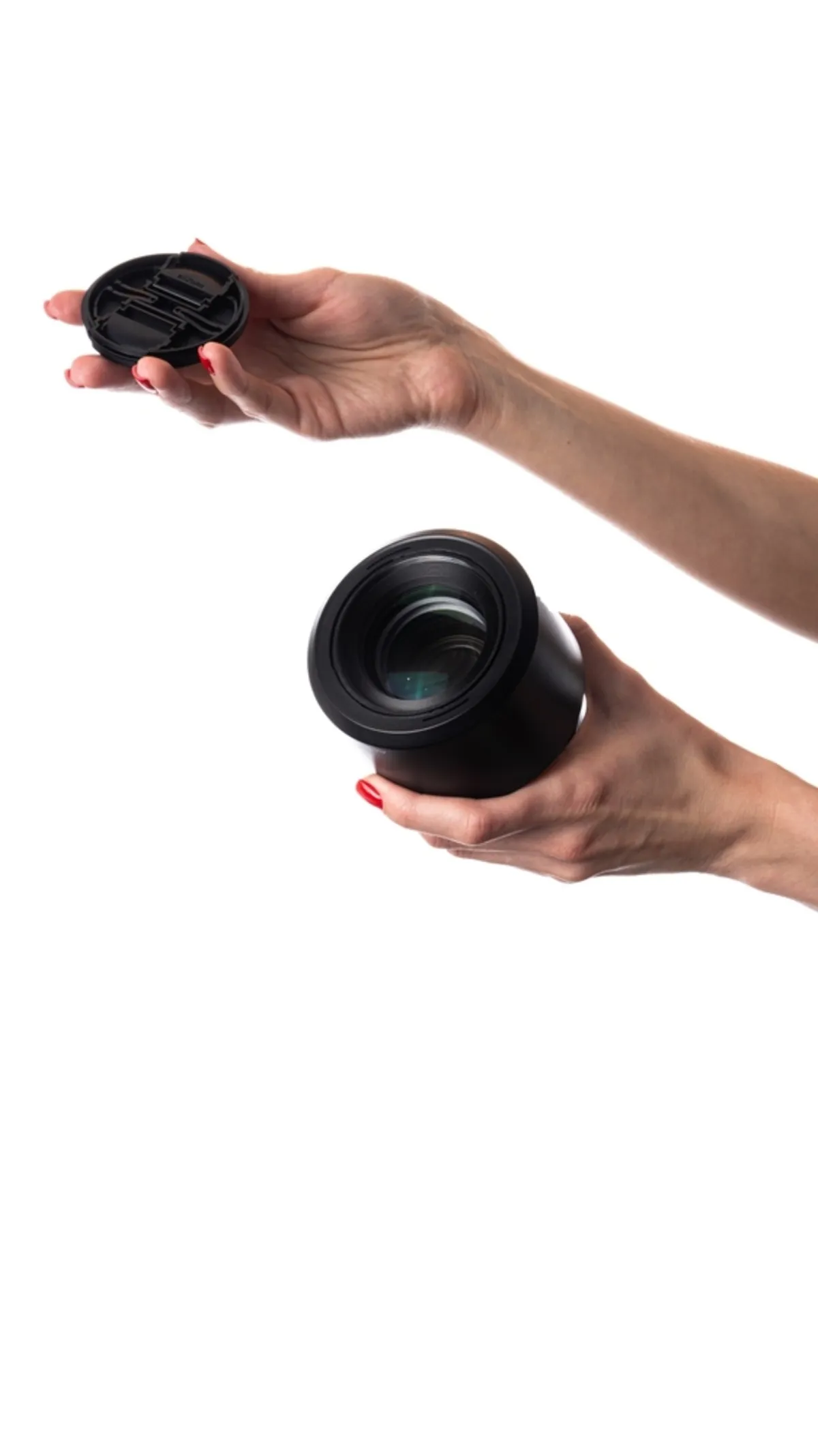 A girl is holding a lens and its cap | Skylum Blog