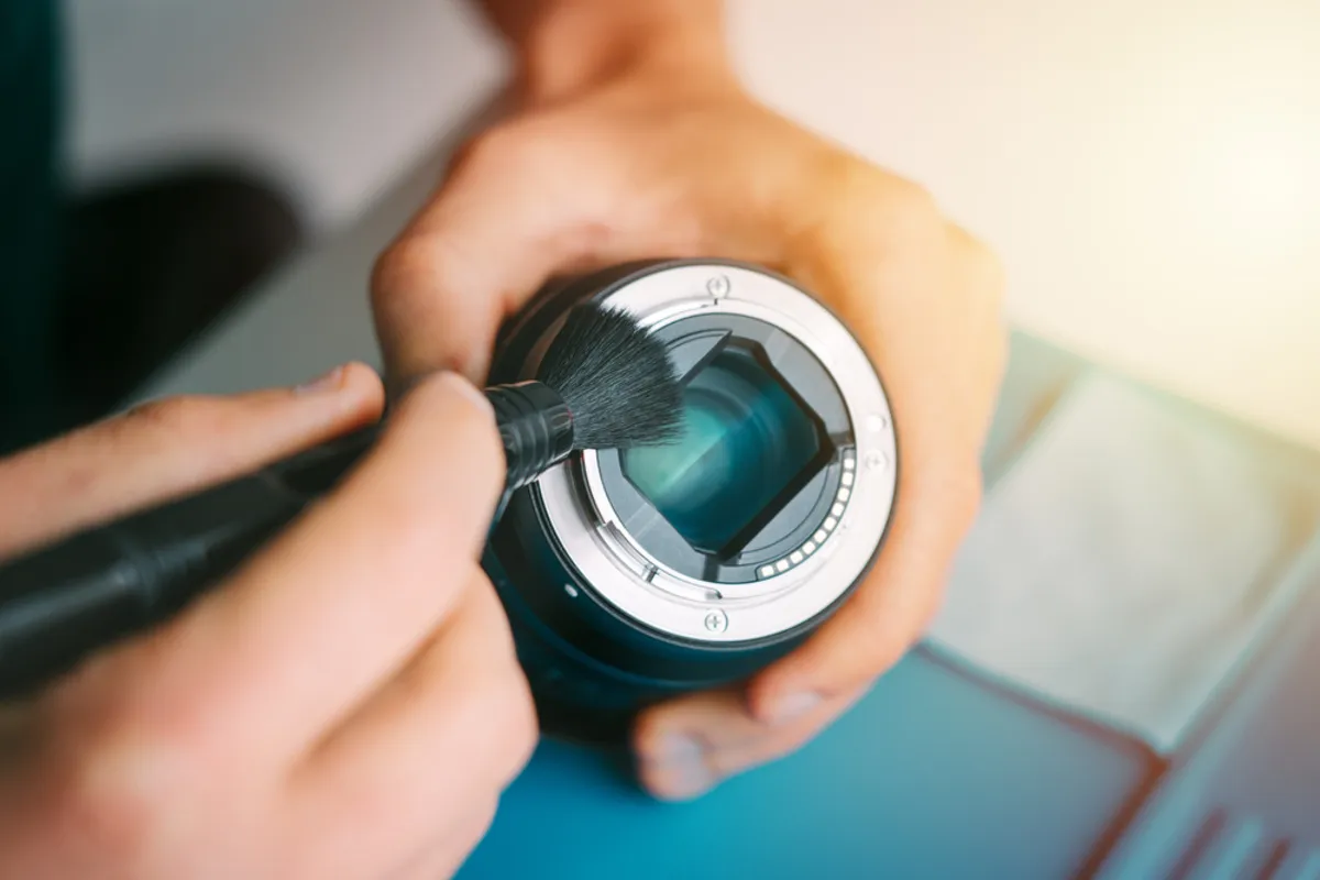 Cleaning the back of the lens with a brush | Skylum Blog