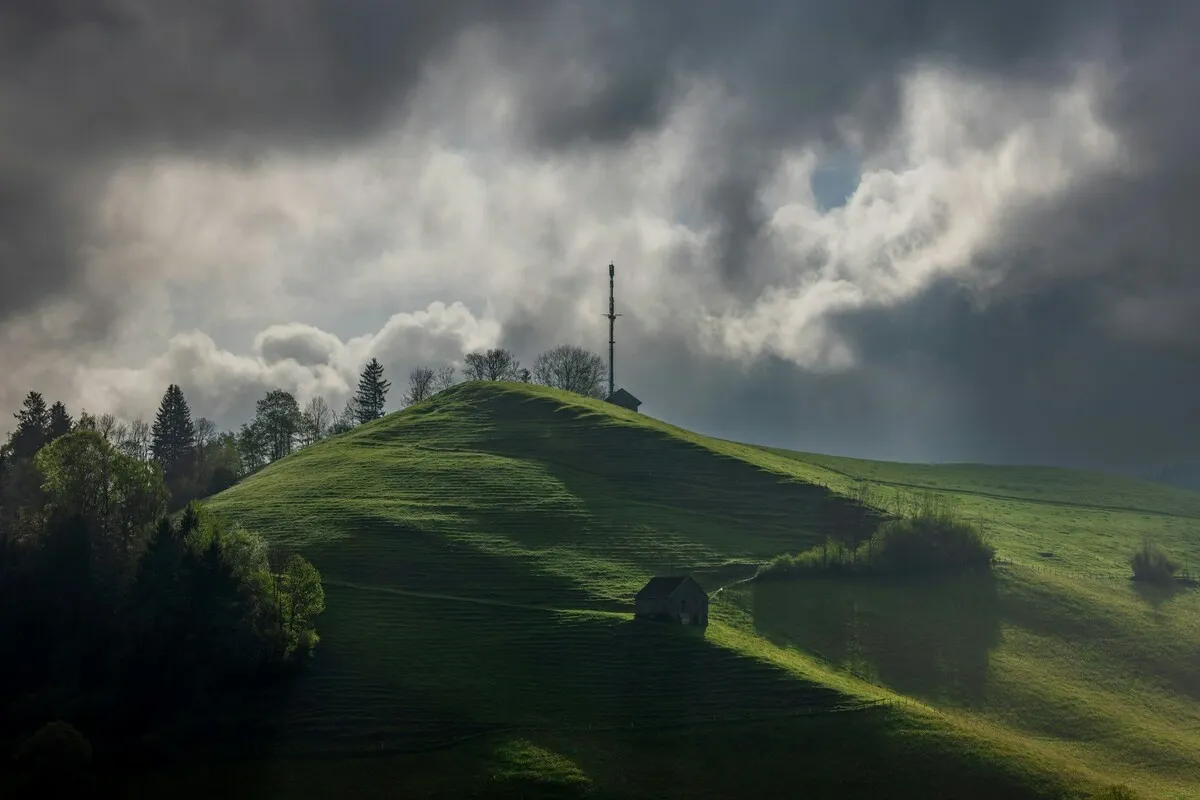 Photo of green hills with clouds | Skylum Blog