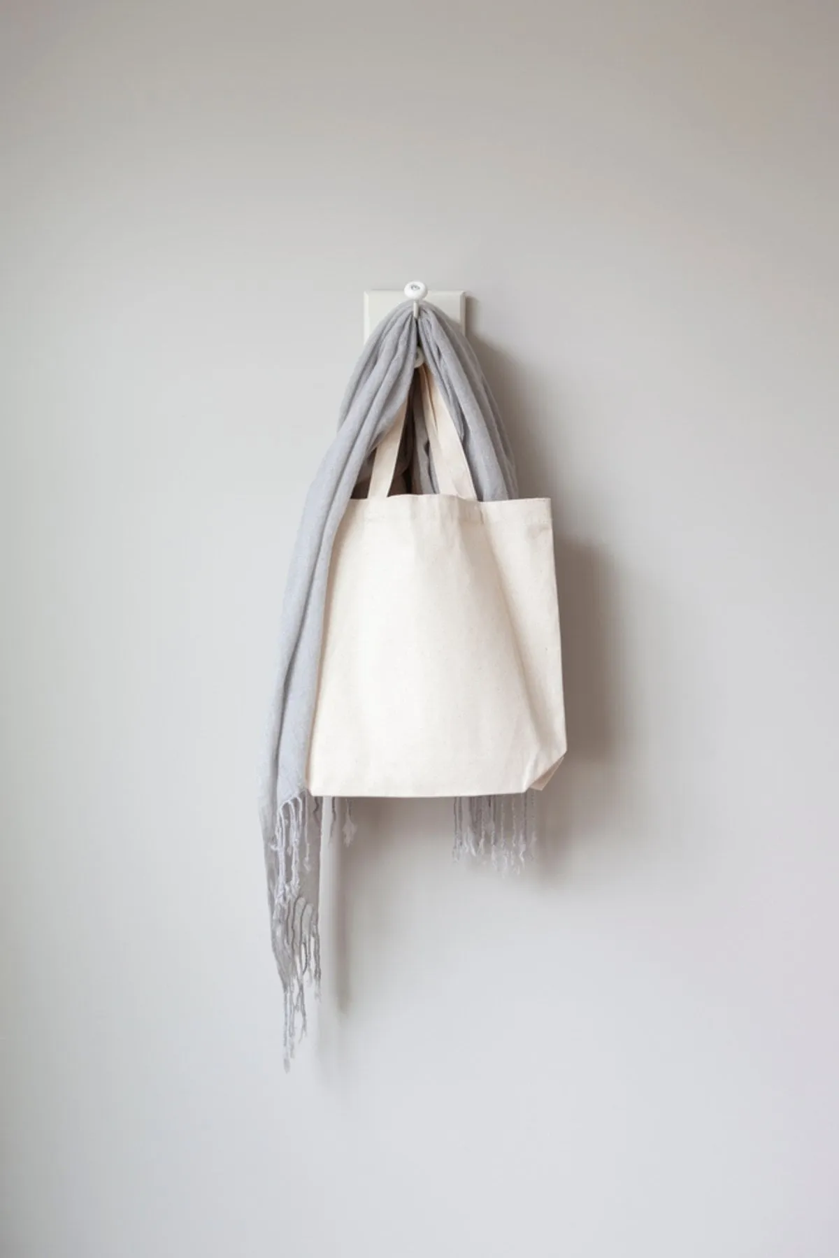 A scarf and a bag are hanging on a hook | Skylum Blog