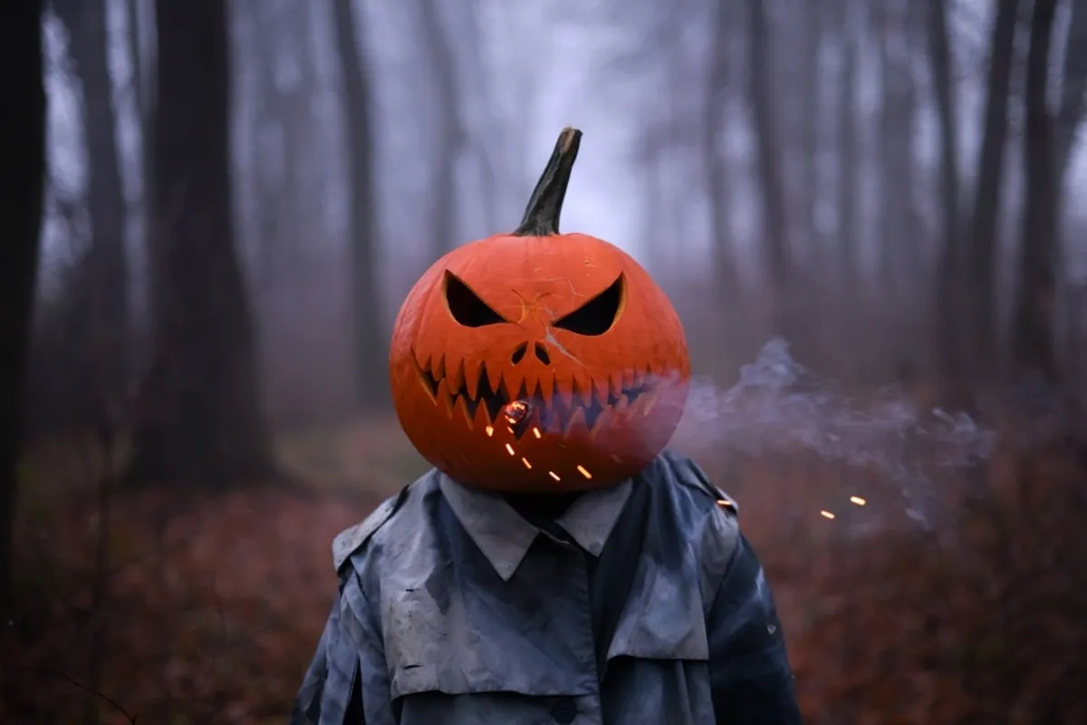 A man in a coat and a pumpkin with a smoke bomb on his head | Skylum Blog
