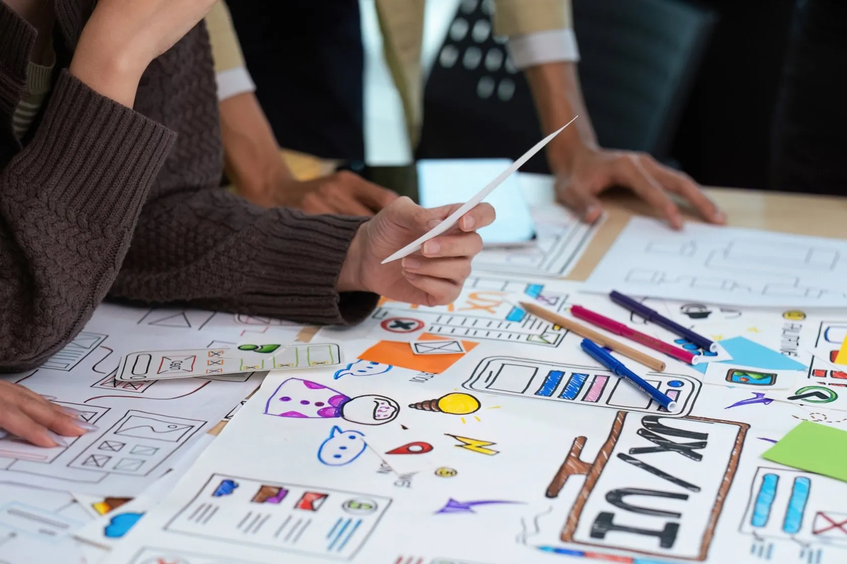 Colleagues look at drawings and ideas | Skylum Blog