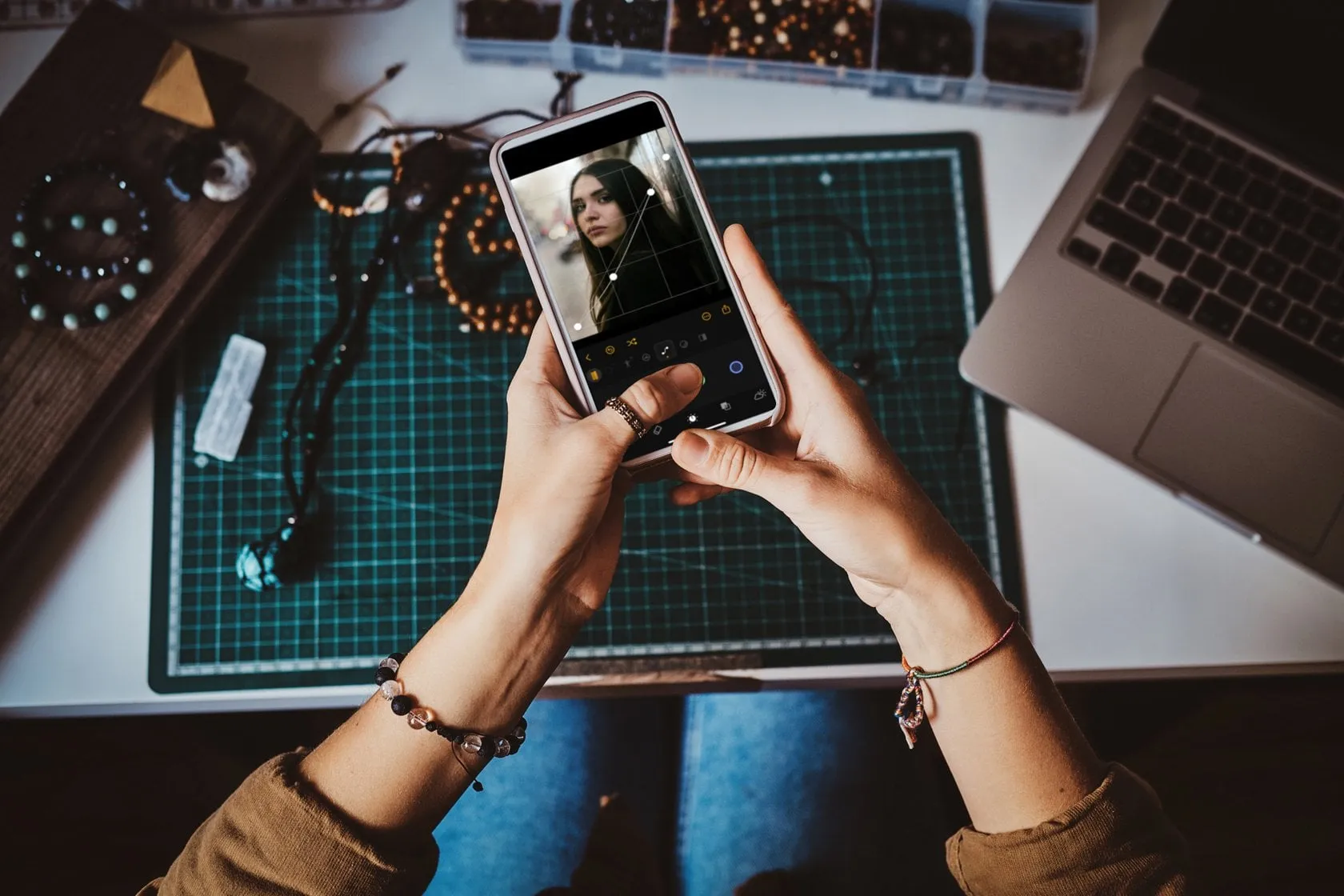 A girl edits a photo on a smartphone | Skylum Blog