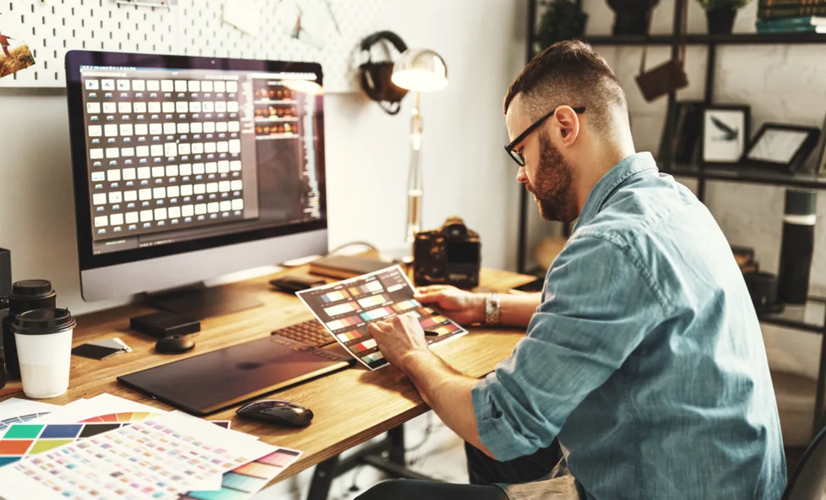 A photographer examines a photo | Skylum Blog