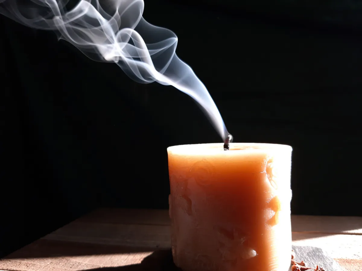 An extinguished candle with smoke | Skylum Blog