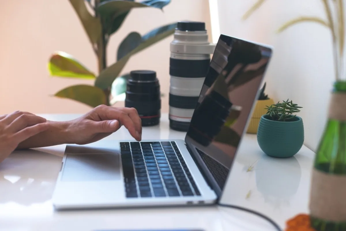 A photographer edits photos on a laptop | Skylum Blog