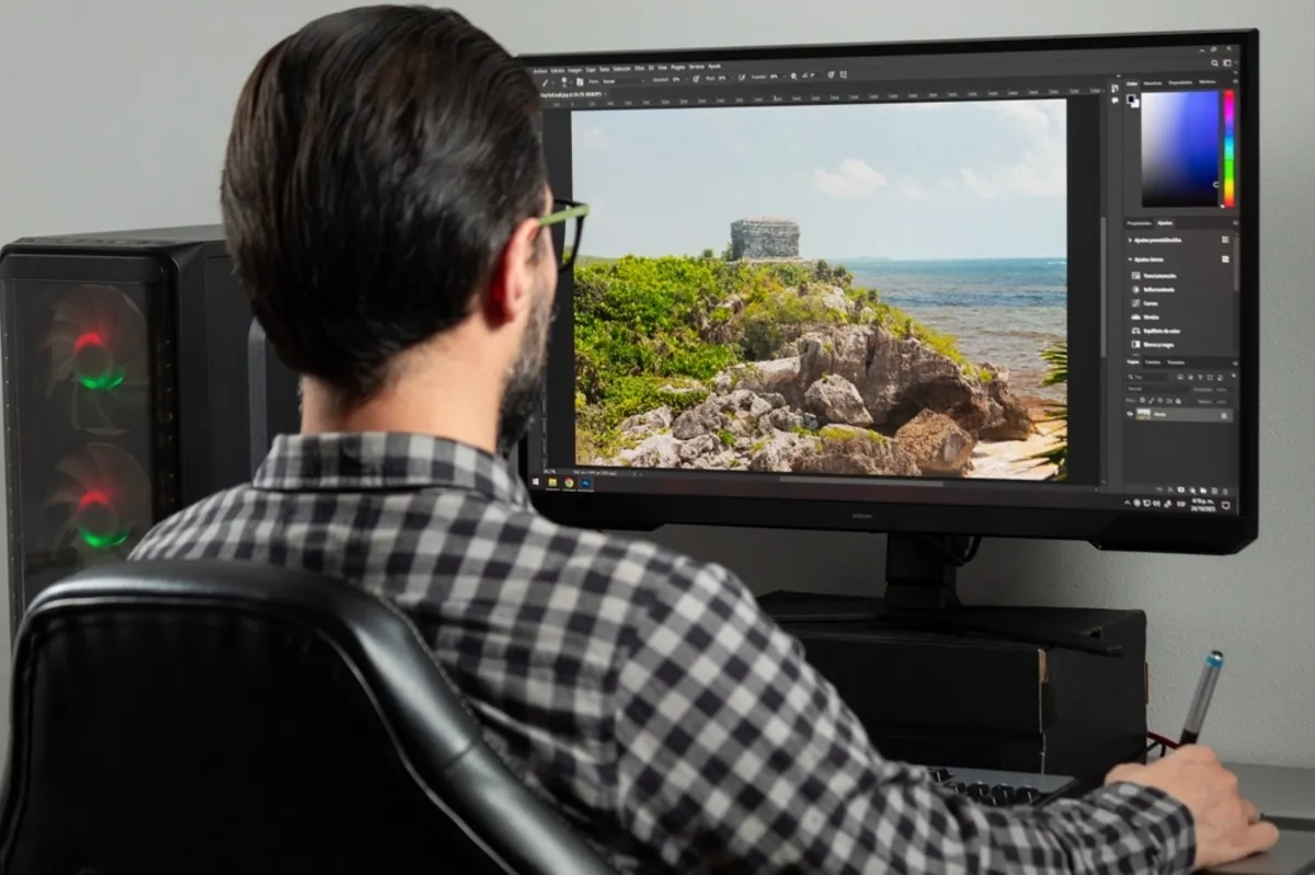 A man edits a photo in Photoshop | Skylum Blog