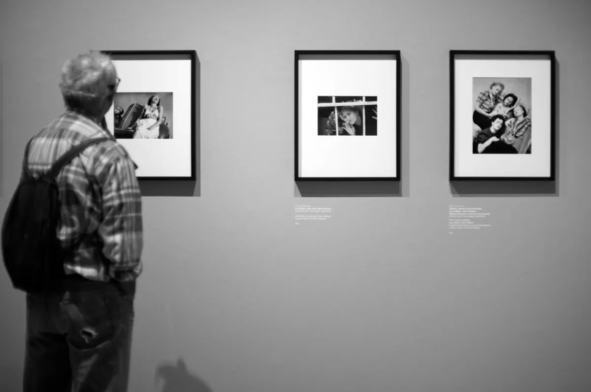A man looks at a photo in a gallery | Skylum Blog