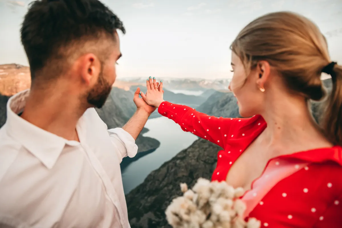 A guy and a girl are looking at a ring on the girl's finger | Skylum Blog