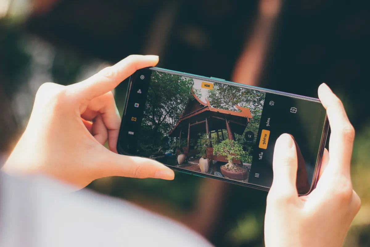 A girl holds a smartphone in her hands | Skylum Blog